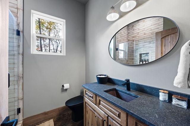 1250 Lost Forest Rd, Ellijay, GA 30536 - bathroom with baseboards, vanity, a shower stall, and toilet
