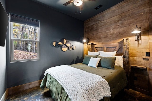 1250 Lost Forest Rd, Ellijay, GA 30536 - bedroom with a ceiling fan, baseboards, visible vents, and wooden walls