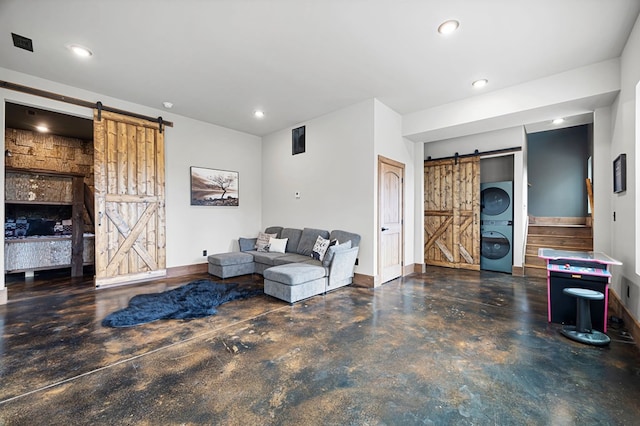 1250 Lost Forest Rd, Ellijay, GA 30536 - living room with stacked washer and dryer, a barn door, visible vents, recessed lighting, and concrete flooring