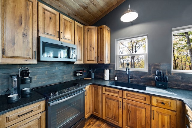1250 Lost Forest Rd, Ellijay, GA 30536 - kitchen featuring black range with electric cooktop, vaulted ceiling, a sink, stainless steel microwave, and tasteful backsplash