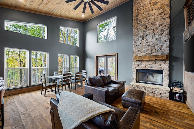 1250 Lost Forest Rd, Ellijay, GA 30536 - living area with hardwood / wood-style floors, a towering ceiling, wooden ceiling, a fireplace, and ceiling fan