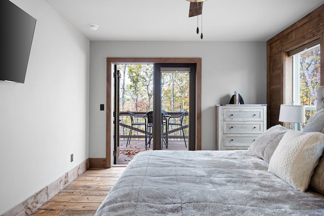 1250 Lost Forest Rd, Ellijay, GA 30536 - bedroom with a ceiling fan, multiple windows, wood finished floors, and access to exterior