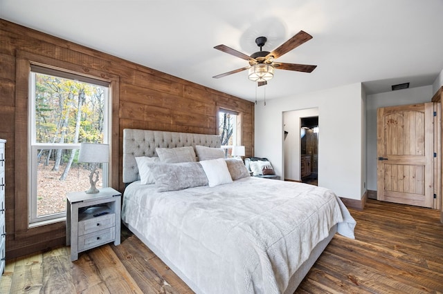 1250 Lost Forest Rd, Ellijay, GA 30536 - bedroom featuring wood walls, a ceiling fan, wood finished floors, and baseboards
