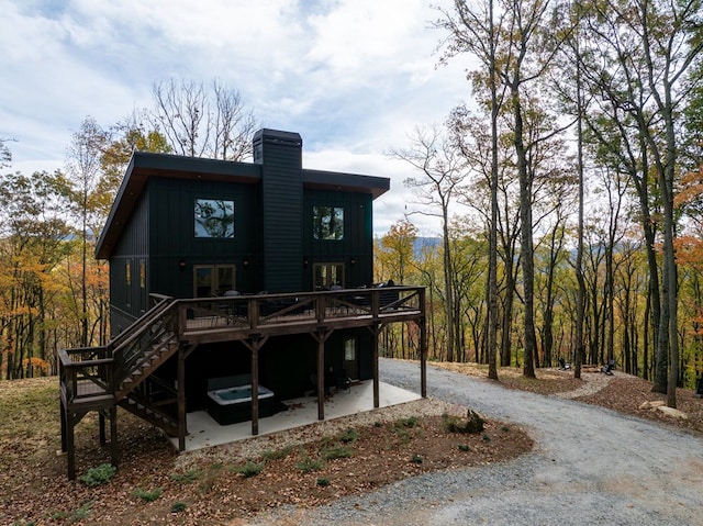 1250 Lost Forest Rd, Ellijay, GA 30536 - rear view of property with a chimney, driveway, board and batten siding, a patio, and a wooden deck