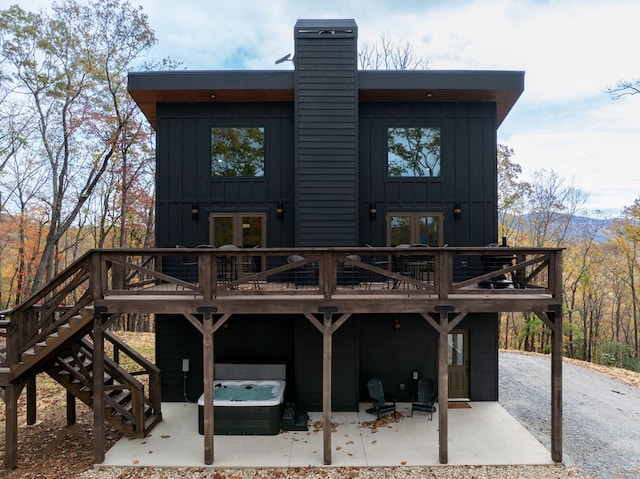 1250 Lost Forest Rd, Ellijay, GA 30536 - back of property featuring a hot tub, a patio area, board and batten siding, and a deck