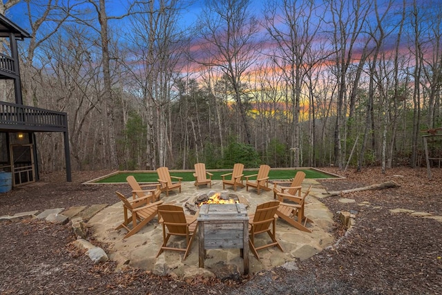 patio terrace at dusk featuring a fire pit