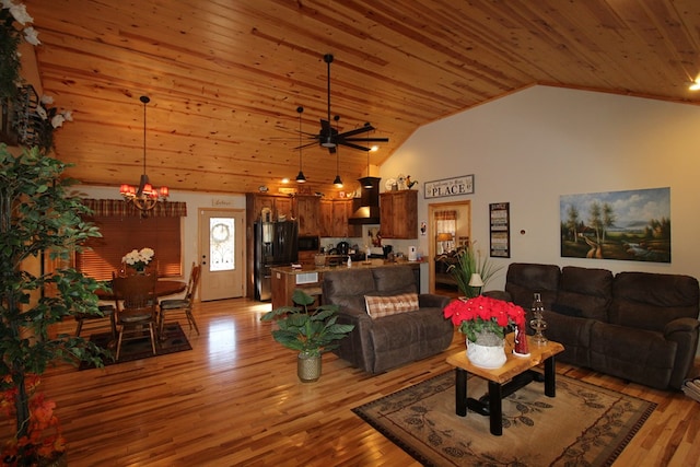 living room with high vaulted ceiling, wooden ceiling, ceiling fan with notable chandelier, and light wood-type flooring