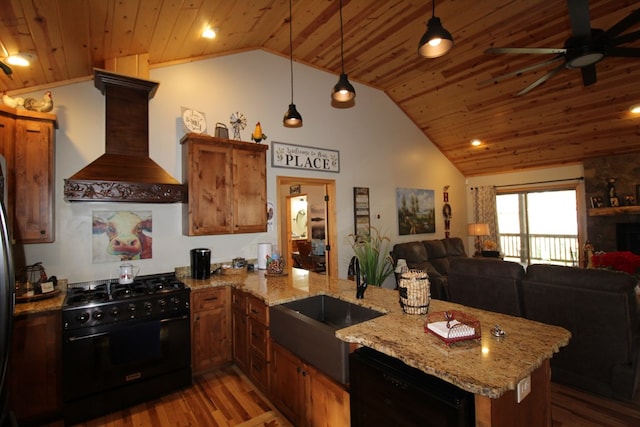 kitchen with custom exhaust hood, black appliances, sink, decorative light fixtures, and kitchen peninsula