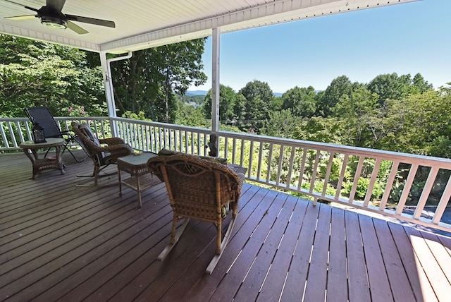 wooden terrace featuring ceiling fan