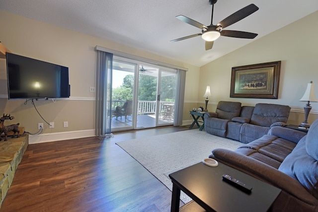 living room featuring ceiling fan, dark wood-type flooring, and lofted ceiling