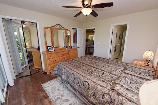 bedroom featuring dark hardwood / wood-style flooring, ceiling fan, a closet, and a textured ceiling