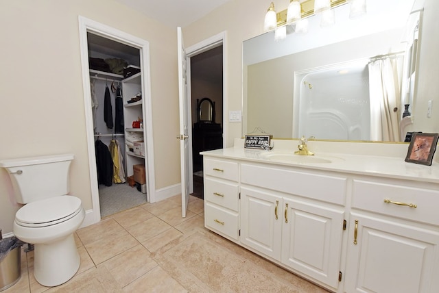 bathroom featuring tile patterned floors, vanity, and toilet