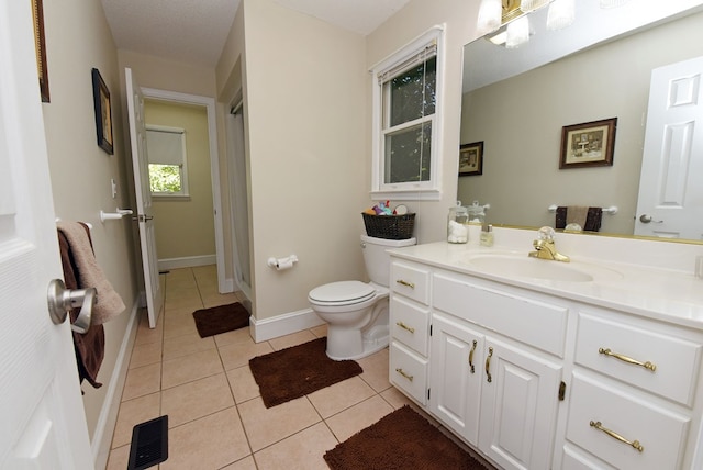 bathroom featuring toilet, a textured ceiling, vanity, and tile patterned floors