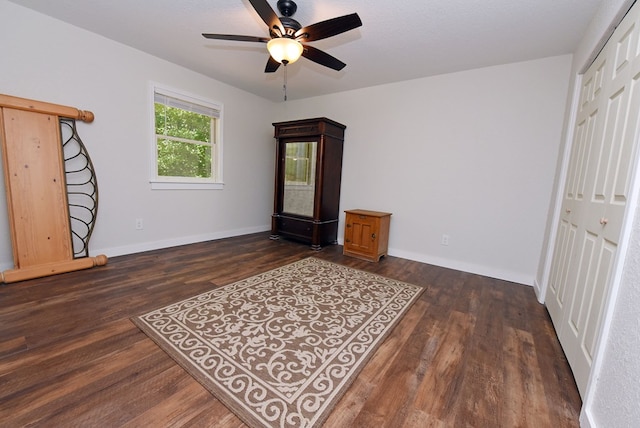 interior space featuring a closet, dark wood-type flooring, and ceiling fan