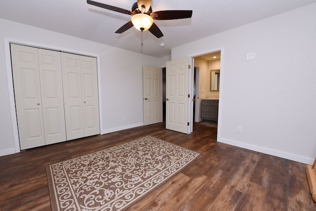 unfurnished bedroom with a textured ceiling, a closet, ceiling fan, and dark wood-type flooring