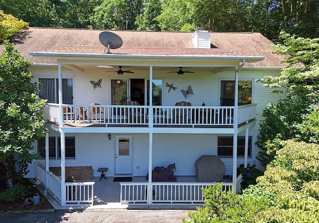 rear view of property featuring ceiling fan