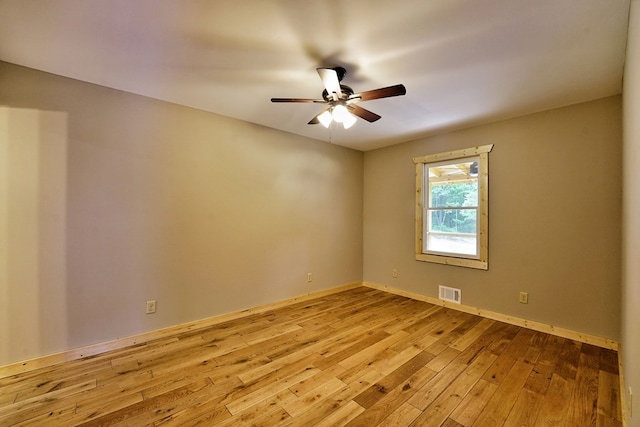 empty room with light hardwood / wood-style flooring and ceiling fan