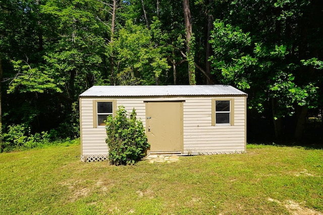 view of outbuilding with a lawn