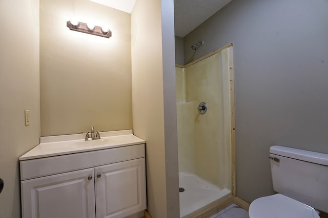 bathroom featuring vanity, toilet, and walk in shower