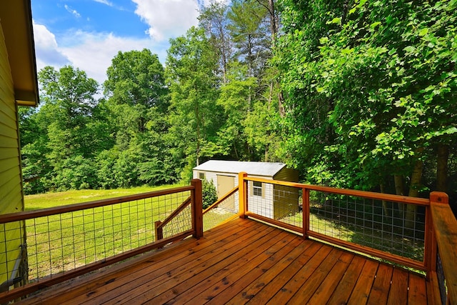 deck featuring a storage shed and a yard