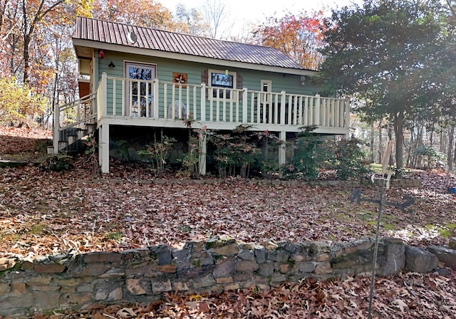 rear view of house featuring a deck