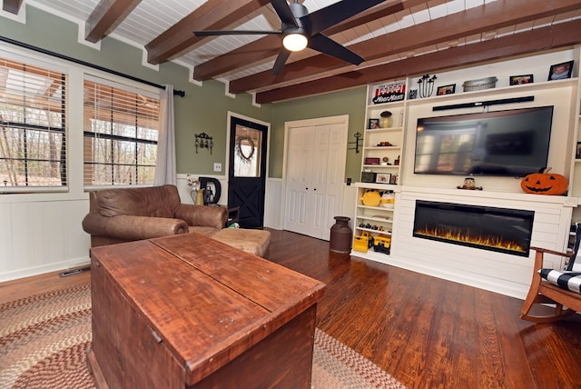 living room featuring wood-type flooring, beamed ceiling, ceiling fan, and wood ceiling