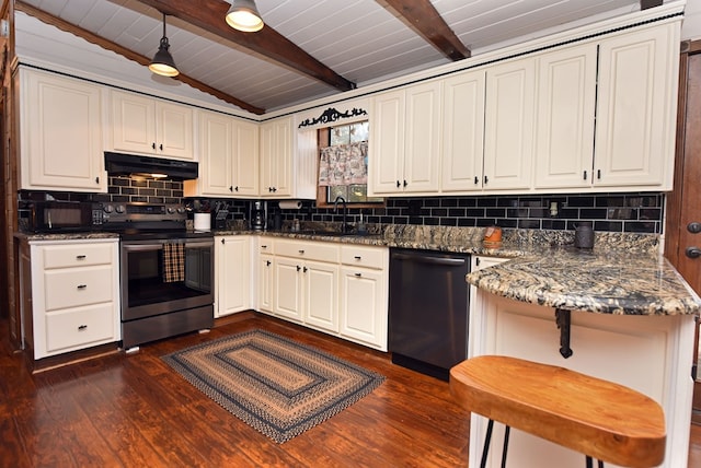 kitchen featuring black dishwasher, sink, stainless steel range with electric cooktop, dark hardwood / wood-style floors, and dark stone countertops