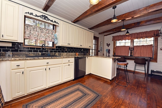 kitchen featuring black dishwasher, kitchen peninsula, a healthy amount of sunlight, and decorative light fixtures