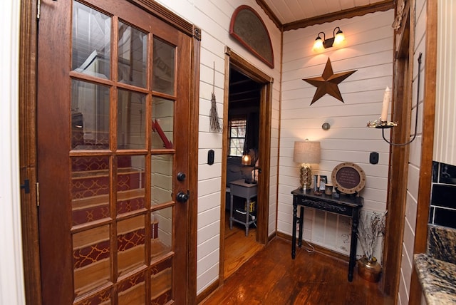 interior space with dark hardwood / wood-style flooring and wood walls