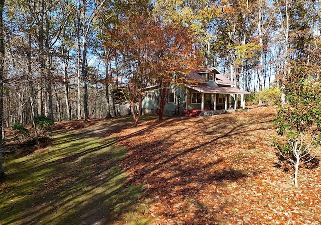 view of yard featuring covered porch