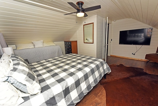 bedroom with wood walls, lofted ceiling, ceiling fan, and dark hardwood / wood-style floors