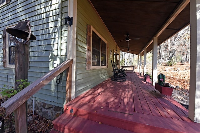 wooden deck featuring covered porch and ceiling fan