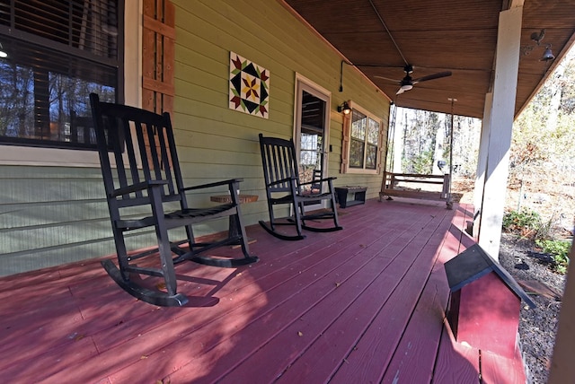 deck featuring covered porch and ceiling fan