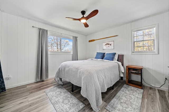 bedroom with wood finished floors and a ceiling fan
