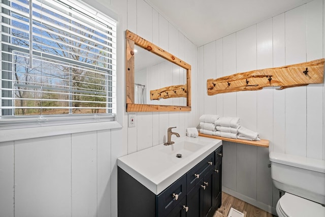 bathroom featuring visible vents, wood finished floors, vanity, and toilet