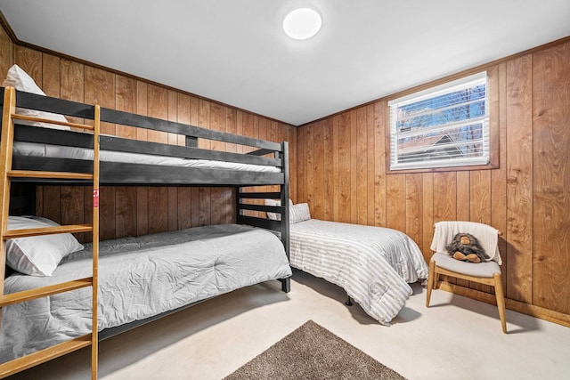 bedroom featuring wooden walls and carpet flooring