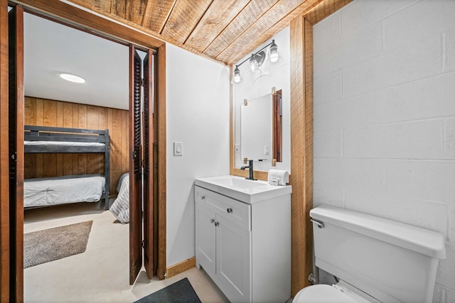 bathroom with wood ceiling, ensuite bath, toilet, and vanity