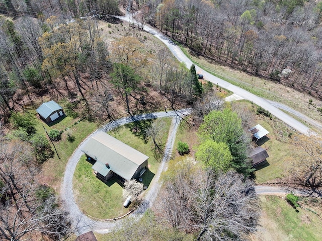 birds eye view of property with a forest view