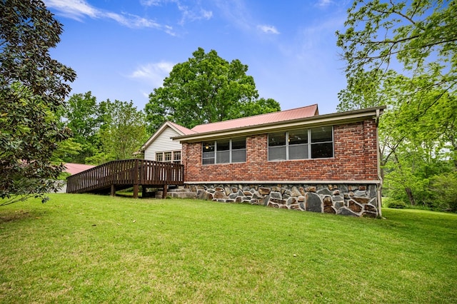 16 Hollow Springs Rd, Blue Ridge, GA 30513 - rear view of house featuring a lawn, a wooden deck, metal roof, and brick siding
