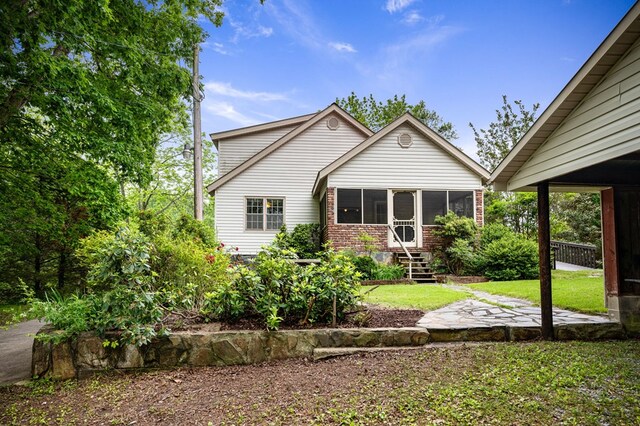 16 Hollow Springs Rd, Blue Ridge, GA 30513 - rear view of property with a sunroom, brick siding, and a lawn