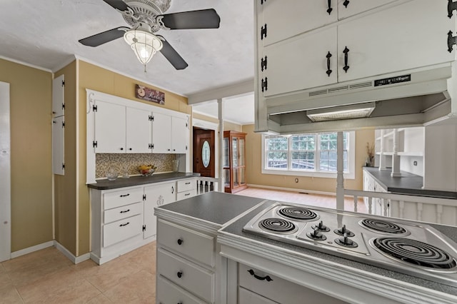 16 Hollow Springs Rd, Blue Ridge, GA 30513 - kitchen with stainless steel electric stovetop, dark countertops, a ceiling fan, white cabinets, and backsplash