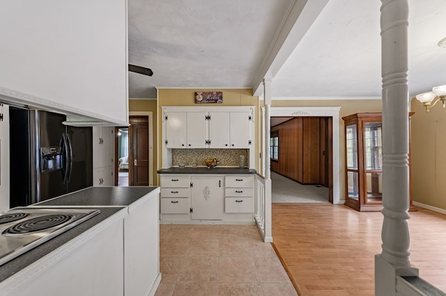 16 Hollow Springs Rd, Blue Ridge, GA 30513 - kitchen with black fridge, white cabinetry, dark countertops, backsplash, and crown molding