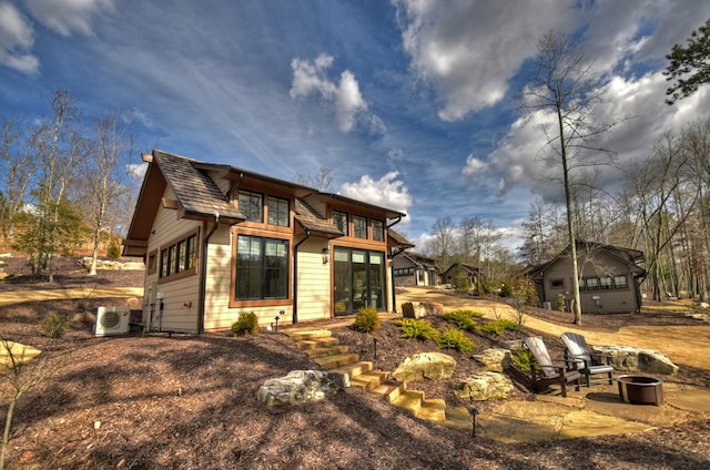 view of front of home featuring a fire pit and a patio