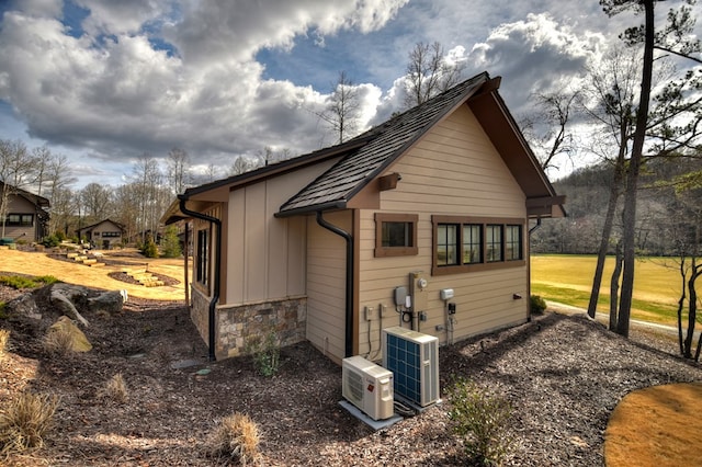 view of side of home with central AC