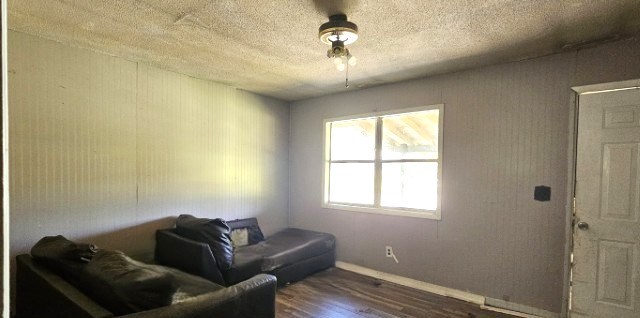 308 Beedie Jones Rd, Chatsworth, GA 30705 - living area with dark wood finished floors, baseboards, and a textured ceiling