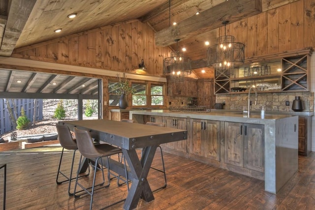 kitchen featuring hanging light fixtures, an inviting chandelier, wood ceiling, dark hardwood / wood-style floors, and beam ceiling