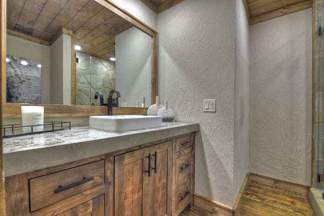 bathroom with hardwood / wood-style floors, wood ceiling, and vanity