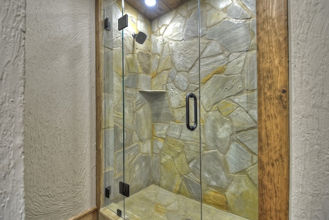 bathroom with a shower with shower door