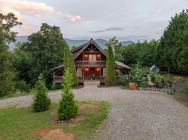 log home featuring a mountain view and a porch