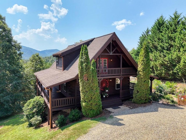 view of front of house featuring a mountain view and roof with shingles